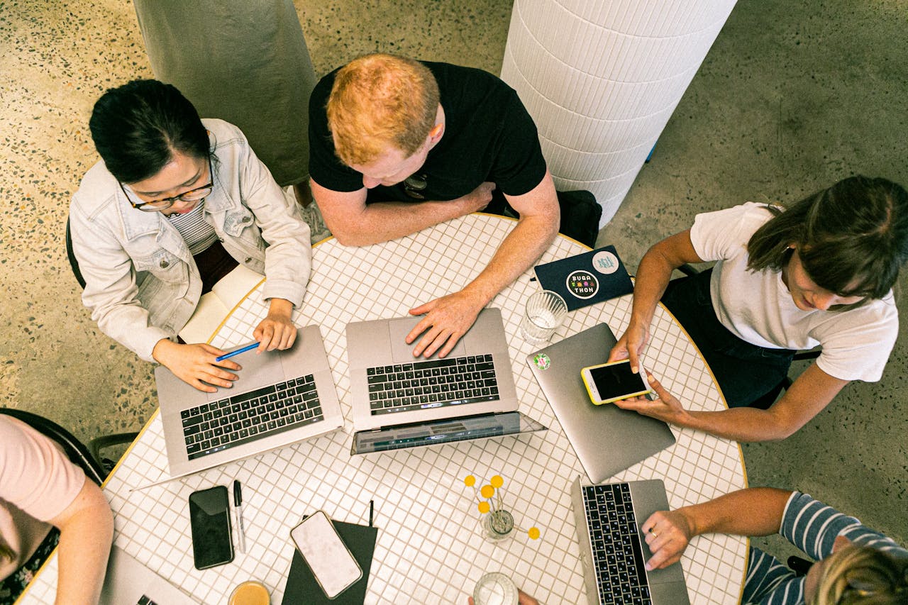 home-services-03 Top view of diverse team collaboratively working in a modern office setting.